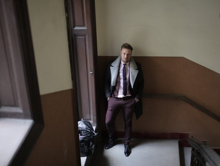 elegant man near doorway in building