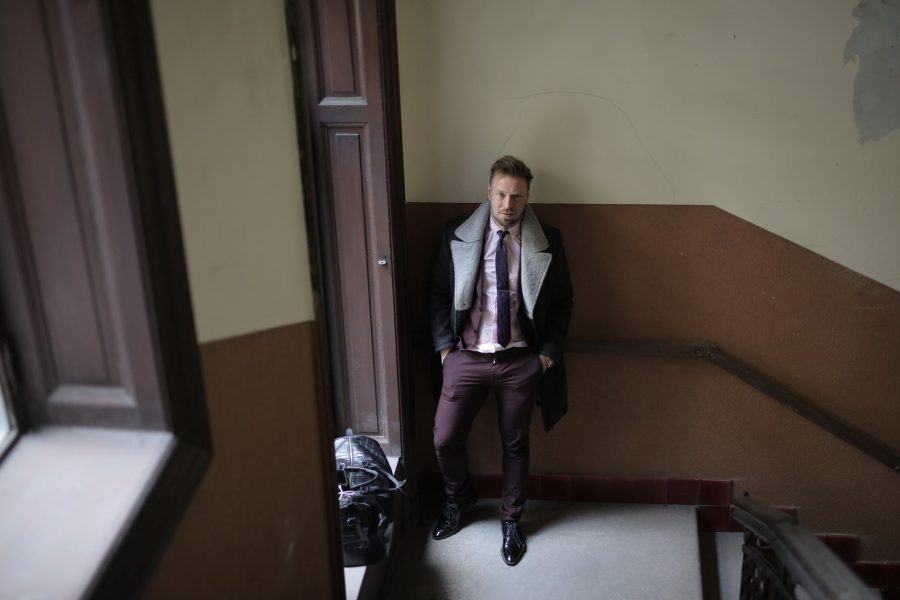 elegant man near doorway in building
