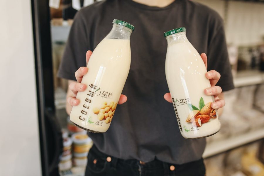 person holding bottles with milk