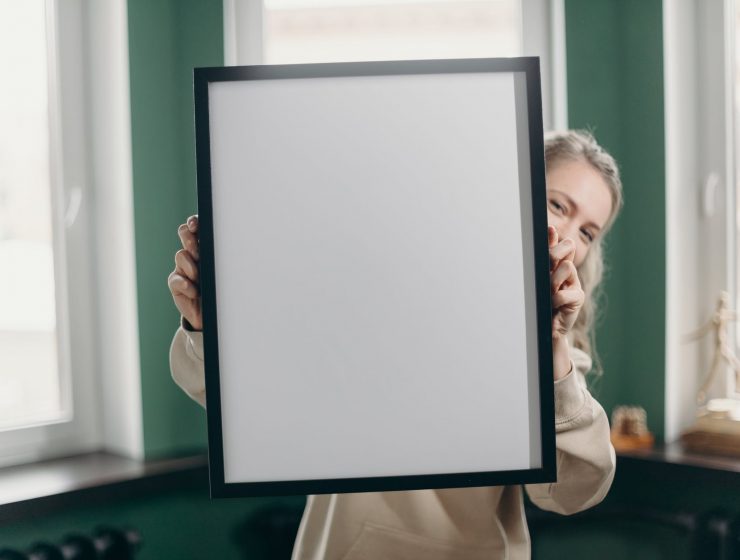 woman holding white and black frame