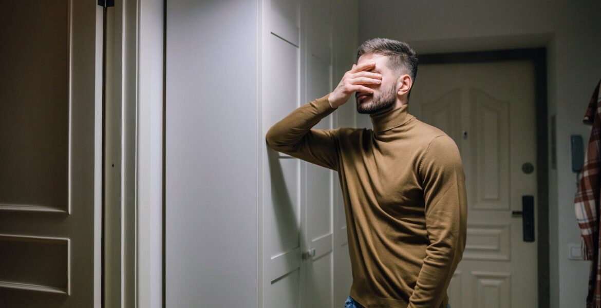 man with his hand on his face