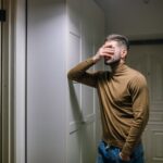 man with his hand on his face