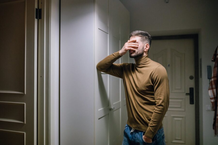 man with his hand on his face